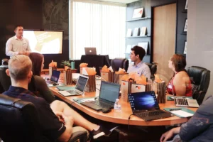 Business team presentation with laptops representing a product demo and B2B sales discussion