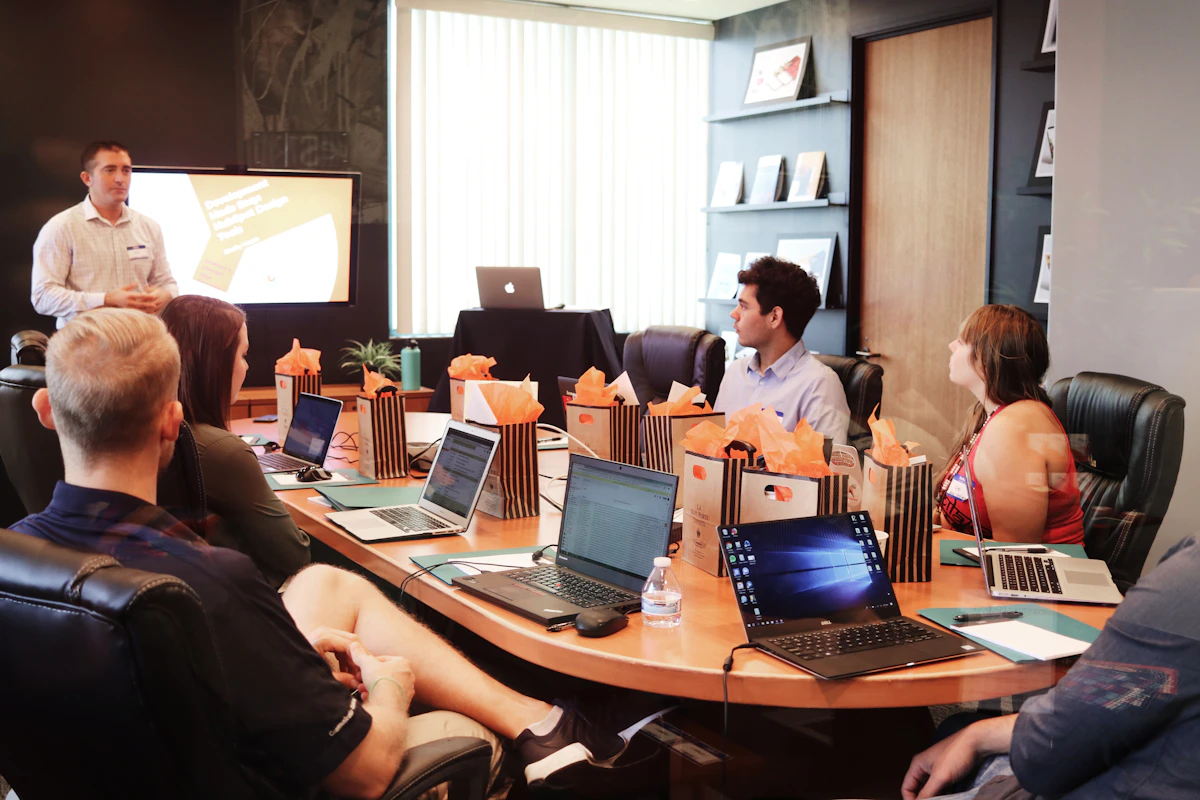 Business team presentation with laptops representing a product demo and B2B sales discussion