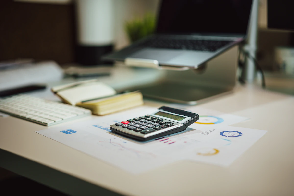 Calculator on a desk representing transparent B2B pricing and plan evaluation