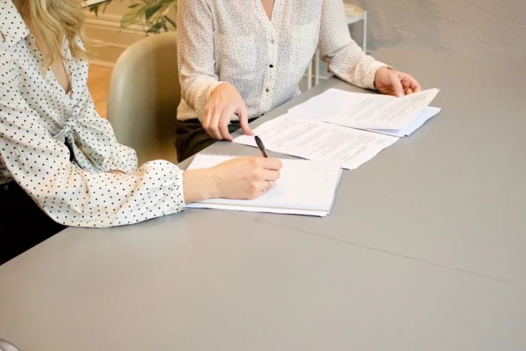 Business professionals reviewing procurement documents and a written request for proposal