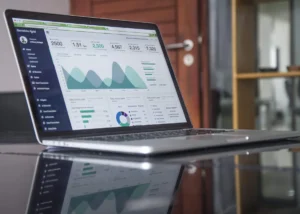 Laptop displaying business analytics and financial charts representing a B2B ROI calculation