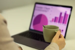 Professional reviewing website analytics and content destinations on a laptop