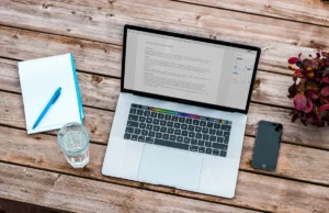 Editorial workspace with a laptop representing publisher pricing, media planning, and rate cards