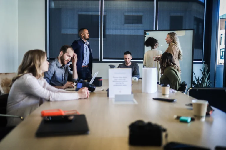 Business professionals reviewing campaign documents together, representing SEO agency expertise