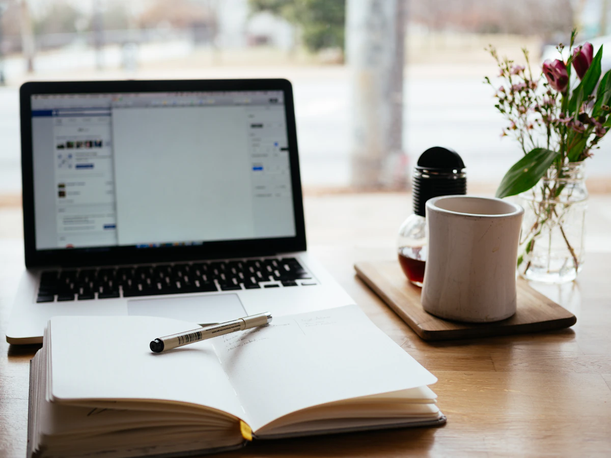 Laptop and notebook representing online learning, course pages, and digital education